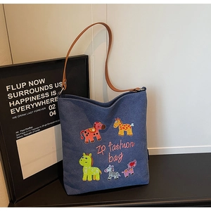 Detail of colorful cartoon animal embroidery on durable blue canvas tote shoulder bag