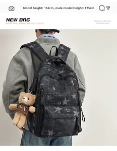 Detail view of large capacity black backpack with star pattern and bear charm on model