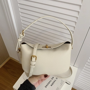 Chic cream leather handbag with lychee texture and gold metal clasp for commuting