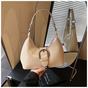 Detailed mirror view of beige hobo bag with silver buckle and smooth PU leather texture