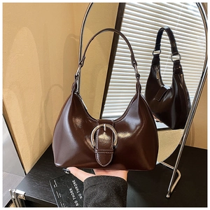 Detail of glossy coffee leather hobo bag with a large silver buckle and smooth finish
