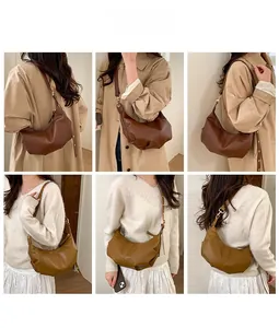 Detailed close-up showing matte leather textures and metal zipper on the crescent bags