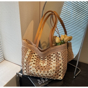 Close-up of crochet straw tote bag with geometric patterns and brown leather strap