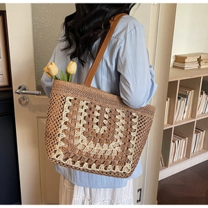 Macro detail of hand-woven straw tote with white crochet waves and long brown leather straps
