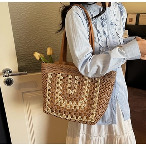 Close-up of geometric crochet pattern on large capacity woven straw beach tote bag