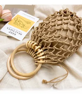 Detailed macro view of woven mesh texture with smooth wooden ring handles and fabric liner