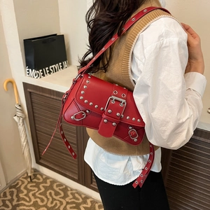 Retro red faux leather underarm bag with silver rivets and metal buckle worn by model