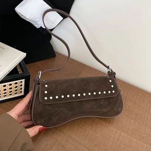 Vintage brown leather underarm bag with white rivets and adjustable shoulder strap