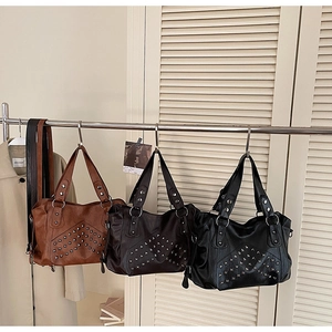 Detailed display of vintage rivet tote bags in brown, dark coffee, and black faux leather