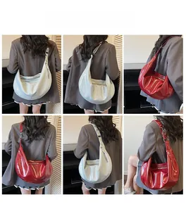 Detailed views of vintage large-capacity half-moon shoulder bags in red and beige finishes