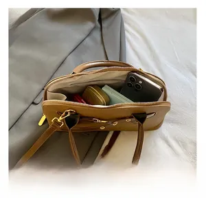 Vue de dessus de l'intérieur du sac en cuir marron montrant sa grande capacité