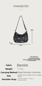 Detail of dark grey denim bag featuring white daisy prints and multiple zipper pockets