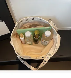 Top view of white tote bag showing spacious interior with tablet and daily essentials