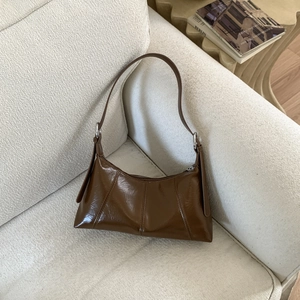 Detail shot of vintage caramel brown leather texture and silver buckle on shoulder bag