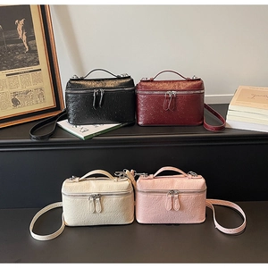 Detail of vintage ostrich texture square handbags in black, red, cream, and pink colors