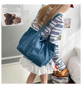 Detail of blue tote bag with white star pattern and handmade print on canvas fabric