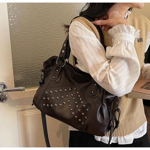 Detailed macro view of vintage brown soft leather texture and silver square rivets decoration
