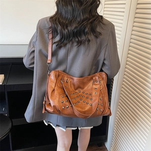 Caramel brown large rivet tote bag made of vintage faux leather with silver studs