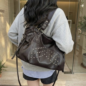 Stylish dark brown leather tote bag with silver studs and adjustable shoulder straps