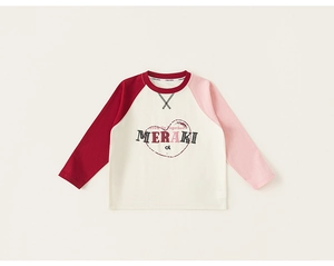 Detail of kids' raglan sleeve top featuring Meraki heart print and premium cotton texture