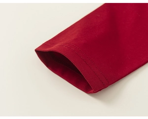 Close-up of double-stitched cuffs on burgundy cotton raglan long-sleeve tee for girls