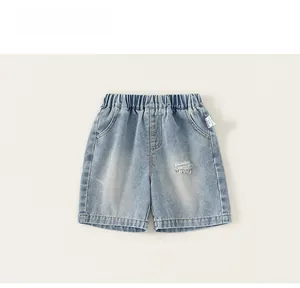 Detailed flat lay of boys light blue distressed denim shorts with elastic waistband
