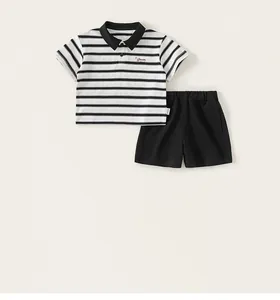Close-up of kids striped polo shirt with Dream embroidery and black shorts set