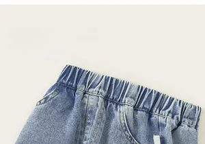Detail of blue denim girls shorts showing elastic waistband and side pocket stitching