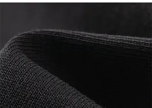 Close-up of high-quality black knit fabric showing fine texture and elastic stitching