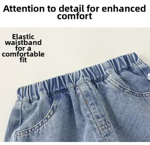 Detail view of girls' blue denim shorts featuring elastic waistband with natural pleats