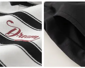 Detail showing red Dream lettering on striped fabric and black shorts side pocket