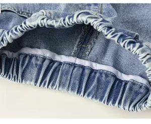Detailed close-up showing neat stitching and elastic waistband on blue denim shorts