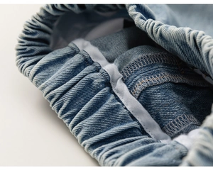 Detail of boys denim shorts showing elastic waistband with high-quality stitching