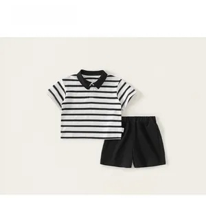 Detail of kids striped polo shirt and black shorts with red Dream embroidery