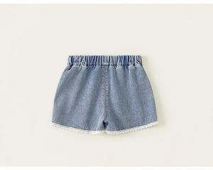 Detail view of girls denim shorts featuring elastic waistband and white lace trim edge