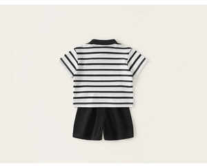Flat lay of striped polo shirt and black shorts set for kids in breathable cotton fabric