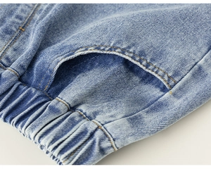 Close-up of light blue denim shorts with elastic waistband and contrast stitching