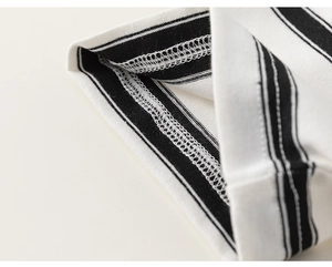 Close-up of overlock stitching and black-white striped cotton knit fabric detail