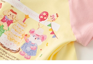 Detail of cartoon bear print and quality cotton stitching on girls' summer t-shirt