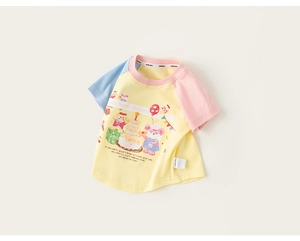 Close-up of kids' yellow t-shirt featuring a cartoon dessert print and colorful sleeves