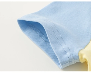 Close-up of color-block short sleeve with precise double-needle stitching on cotton fabric