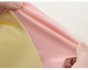 Detail showing the elastic stretch and ribbed texture of this color-block kids T-shirt