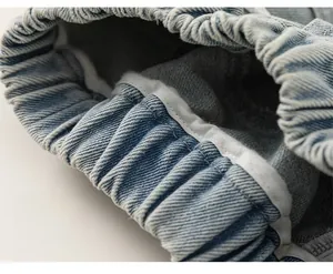 Dettaglio dei pantaloncini in denim azzurro con vita elastica e cuciture rifinite