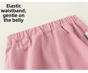 Detailed macro view of the comfortable elastic waistband on pink cotton blend trousers
