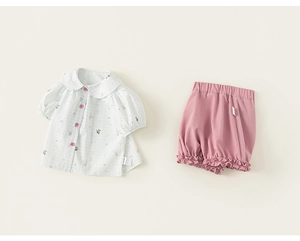 Detail of baby girl summer outfit featuring Peter Pan collar shirt and bloomers