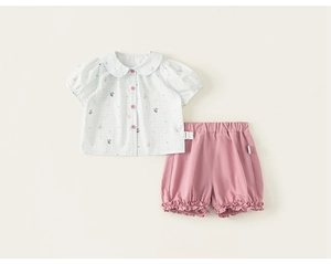 Close-up of girls' summer cotton set featuring plaid Peter Pan collar shirt and pink shorts