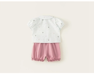 Back view of summer toddler girls outfit with white doll shirt and pink ruffled shorts
