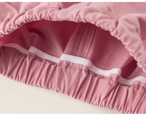 Detailed macro view of the elastic waistband on pink cotton linen toddler shorts