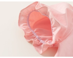 Close-up of pink cotton knit sleeve with elastic ruffled edges and fine stitching