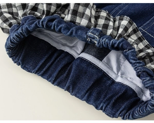 Detailansicht der elastischen Gingham-Rüschen und Denim am Saum der Mädchen-Jeanshosen